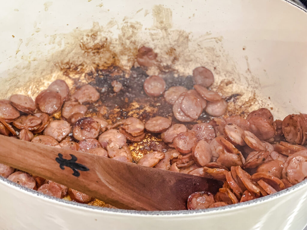 browning sausage in pot